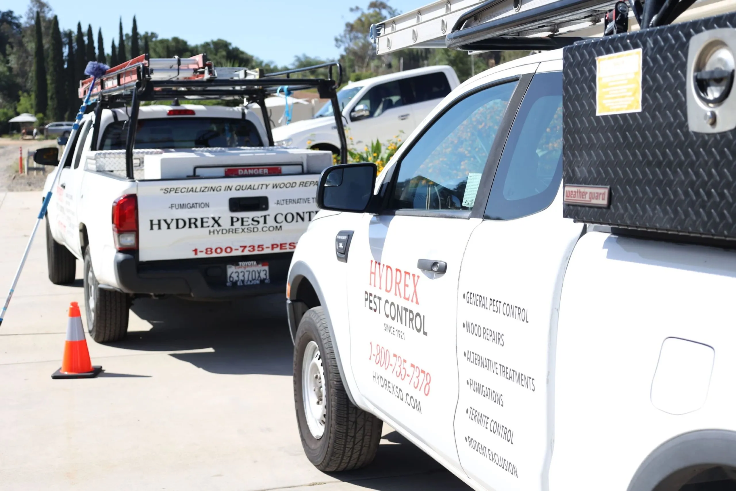 Hydrex Pest Control San Diego service trucks parked at a San Diego job site